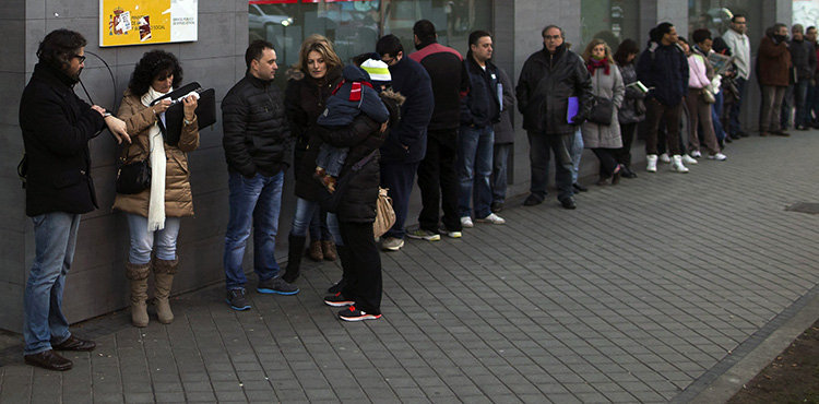 People wait in line to enter an unemployment registry office in Madrid, Spain, Thursday, Jan. 23, 2014.